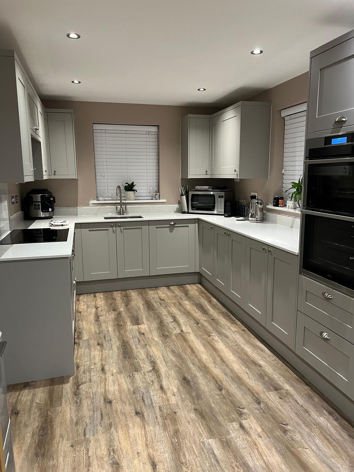 After: the finished grey shaker kitchen in the same room