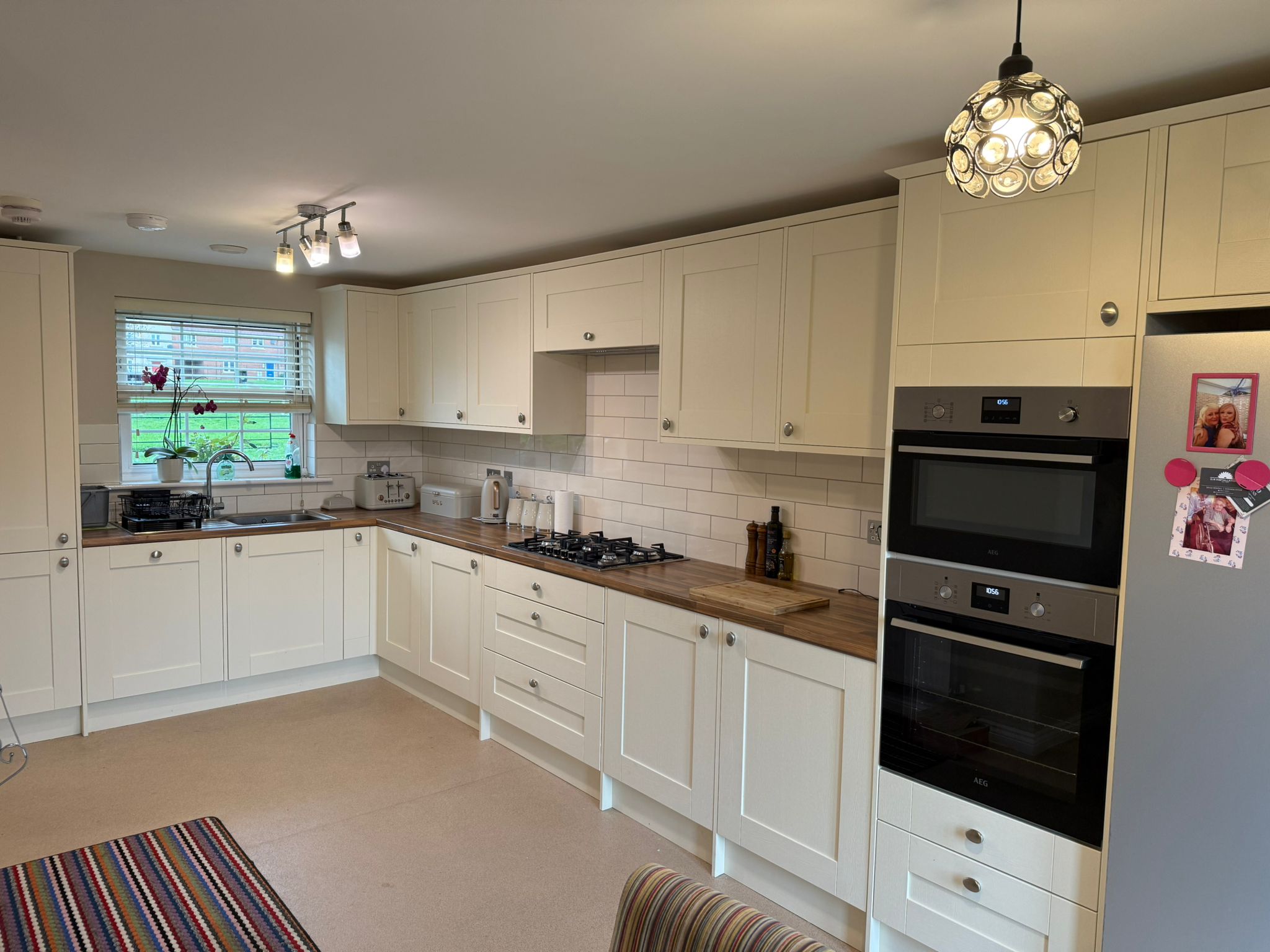 Cream shaker kitchen with a double oven and wood worktops